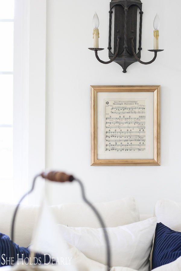 Summer Farmhouse Decor with sheet music in gold frame on wall