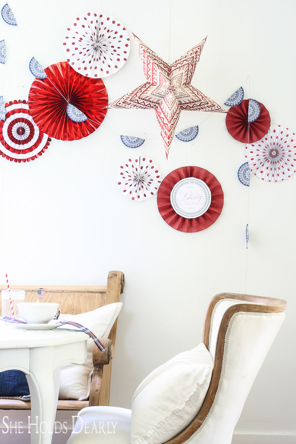 This inexpensive backdrop is perfect for the 4th of July! Check out how to make your own patriotic paper fan wall decor.